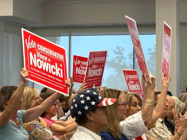 Supporters holding Vince Nowicki signs