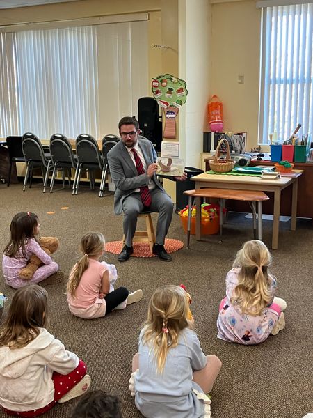 Commissioner Vince Nowicki reading to young students